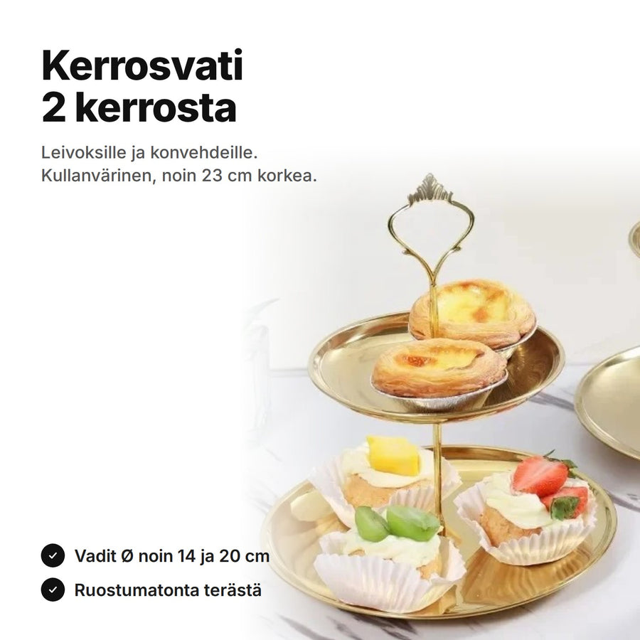 Kaksikerroksinen kerrosvati kullanväristä ruostumatonta terästä, vadeilla pieniä torttuja ja kermaleivoksia – noin 23 cm korkea, vadit Ø noin 14 ja 20 cm