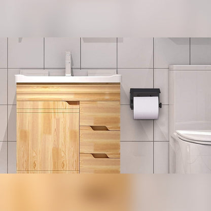 WC-paperiteline laatoitetulla kylpyhuoneen seinällä pesualtaan ja WC-istuimen välissä