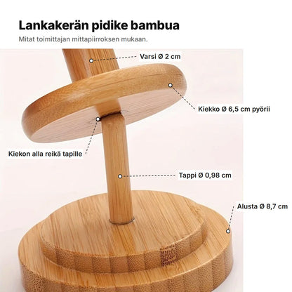 Lankakerän pidike selitettynä: varsi Ø 2 cm, kiekko Ø 6,5 cm pyörii, kiekon alla reikä tapille, tappi Ø 0,98 cm ja alusta Ø 8,7 cm