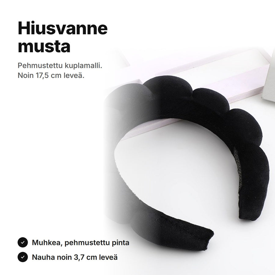 Musta pehmustettu hiusvanne kuplapinnalla, noin 17,5 cm leveä ja nauha noin 3,7 cm