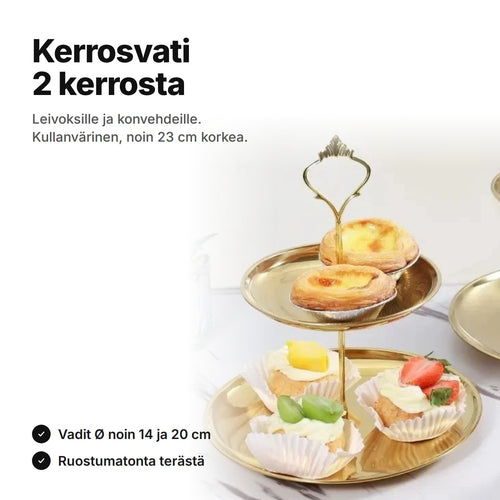 Kaksikerroksinen kerrosvati kullanväristä ruostumatonta terästä, vadeilla pieniä torttuja ja kermaleivoksia – noin 23 cm korkea, vadit Ø noin 14 ja 20 cm
